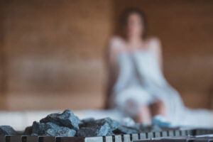 A women relaxing in a sauna.