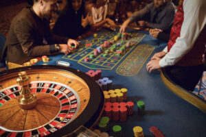Hand of a croupier on a roulette whell in a casino. Roulette betting poker. Gambling in a casino.