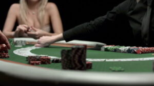 HD1080p: DOLLY shot of an unrecognizable female dealer spreading cards on a poker table.